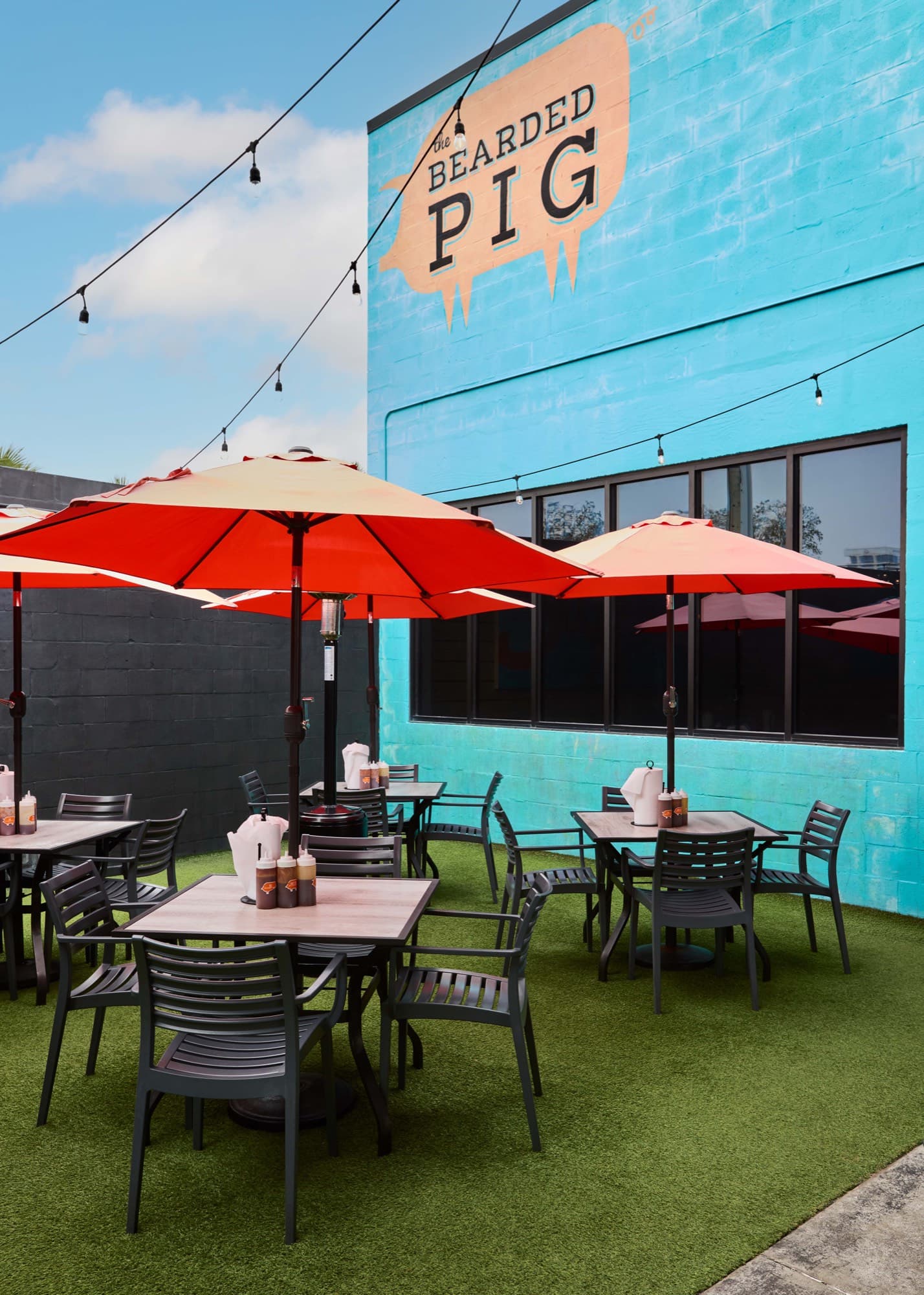 Outdoor patio seating under umbrellas at The Bearded Pig