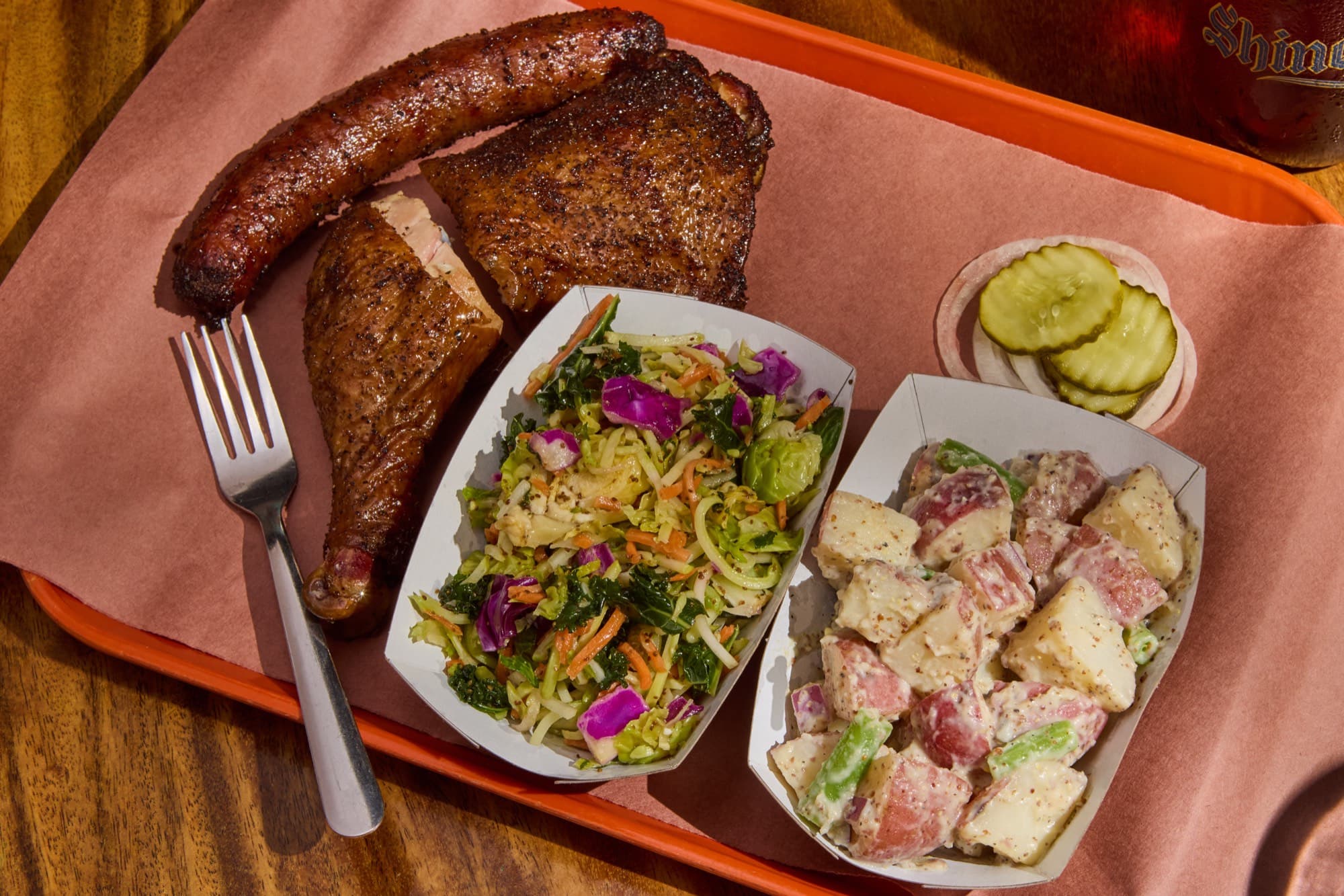 House sausage and smoked chicken plate with barbecue sides