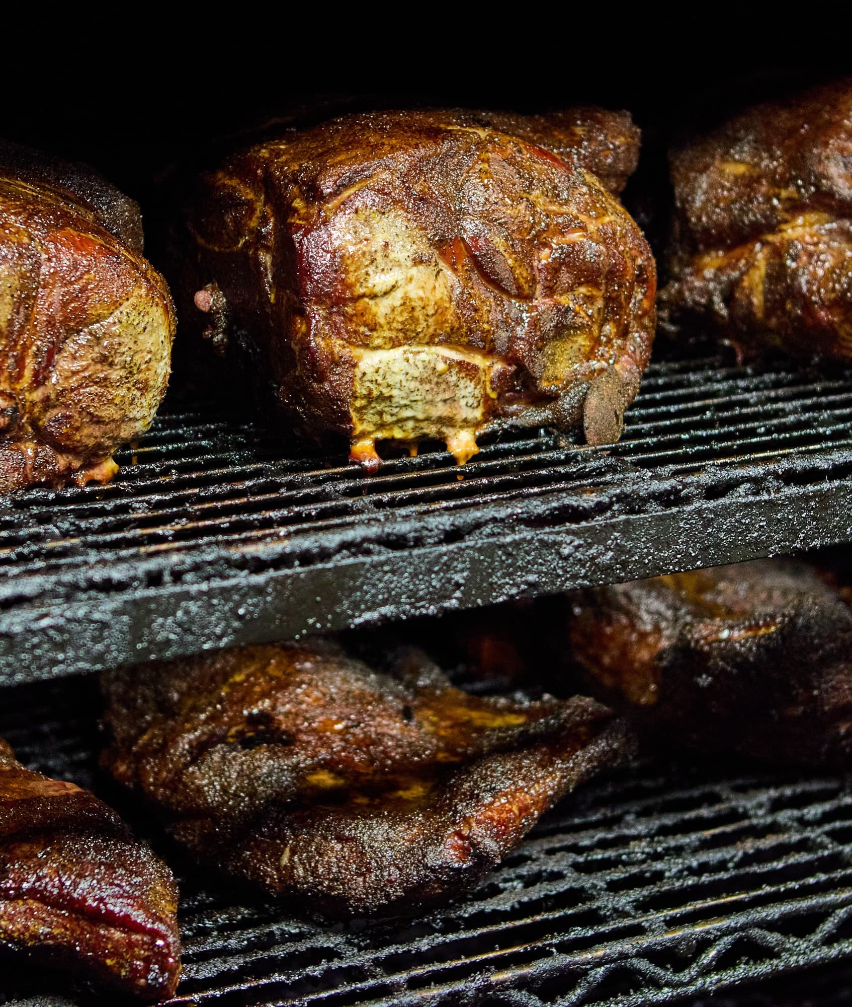 Pork shoulders smoking on the racks at The Bearded Pig